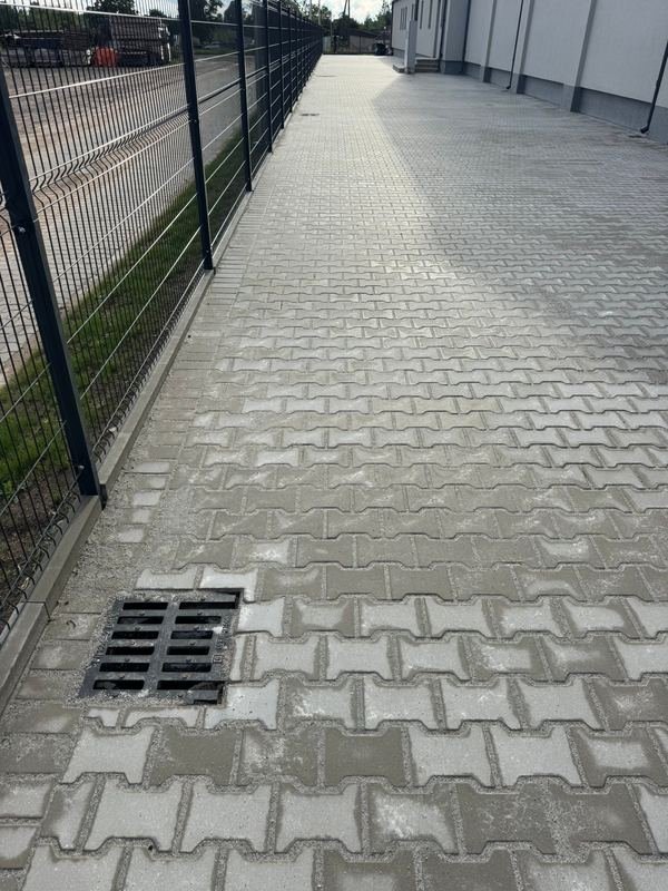 Trinkelių danga su lietaus surinkimo grotelėmis ir tvora